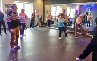 Regelmäßige Besuche im Fitnessstudio Gruppe beim Bewegungstraining im Kursraum des Fitnessstudios
