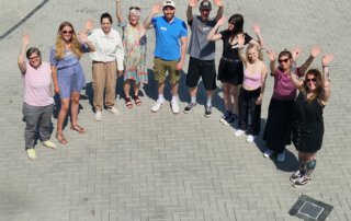 Seniorenolympiade mit Herz und jeder Menge Bewegung Ergotherapieschülerinnen und -schüler winken fröhlich in die Kamera